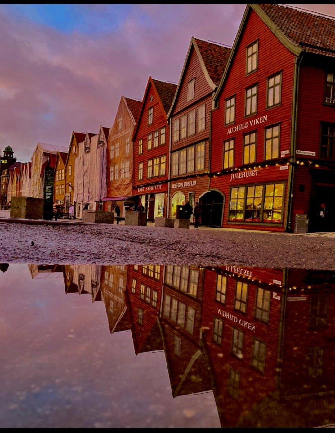 Bryggen in Bergen at sunset, mirrored in the cobblestones
